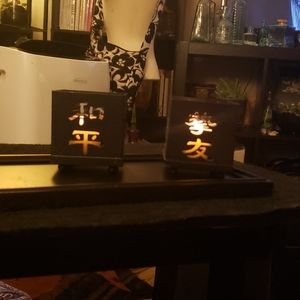 Pair of Kanji-Carved Metal Candle Holders